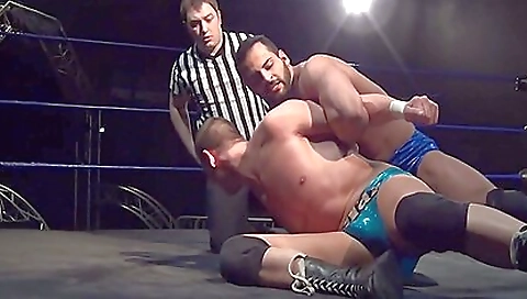 Two men are wrestling with one another in a tight match