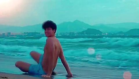 Brunette teen 18+ is stripping naked before getting on a surfboard