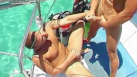 Beach tattooing show with two men showing their tattoos